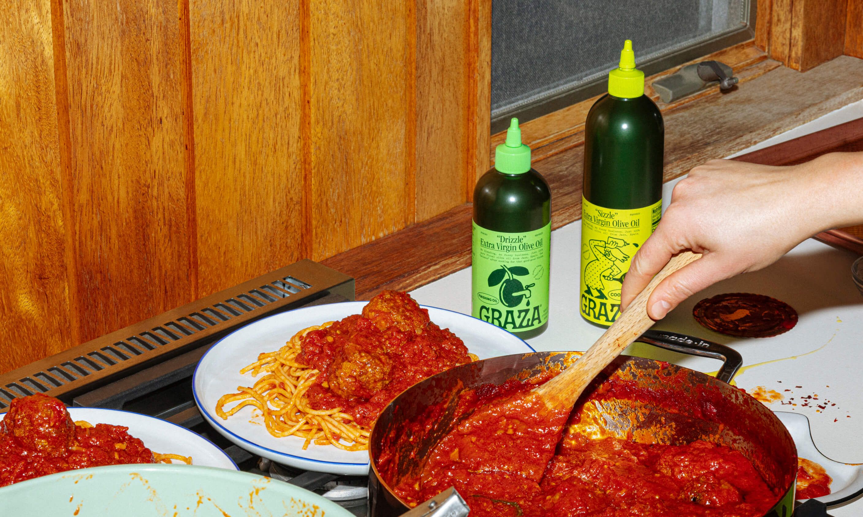 Graza squeeze bottle being used in a kitchen